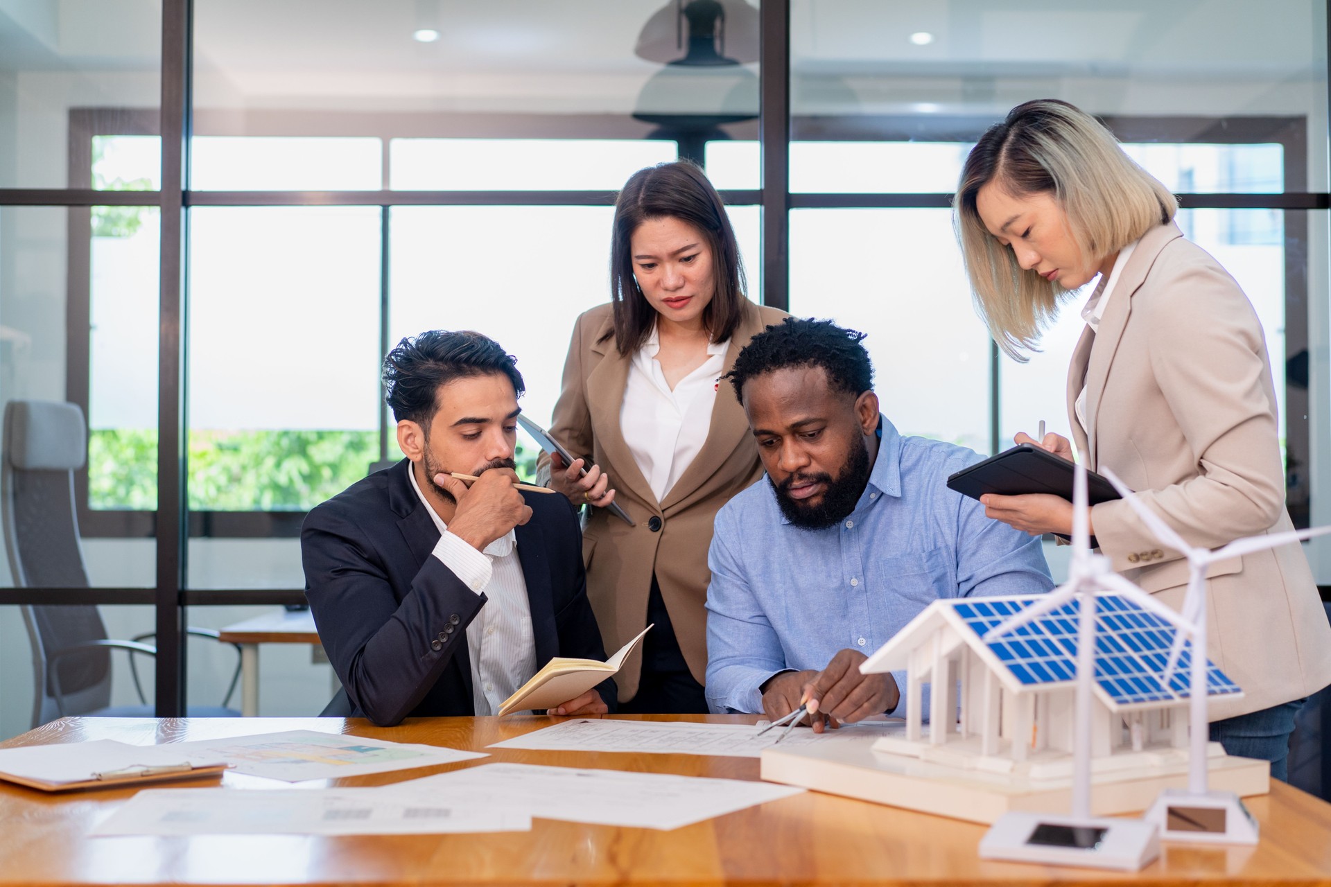 team of multiethnic coworker meeting on solar roof system project